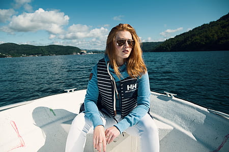 woman ride on powerboat wearing Helly Hansen vest thumbnail
