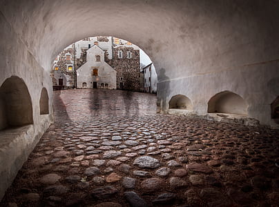 white concrete tunnel across building thumbnail