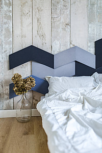Designer bedroom with an ornamental golden plant in a jar by the bed thumbnail