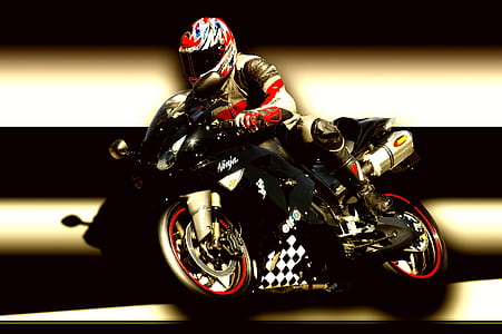 person riding black Kawasaki Ninja sports bike thumbnail