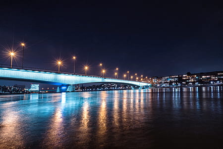bridge over body of water during nighttime thumbnail