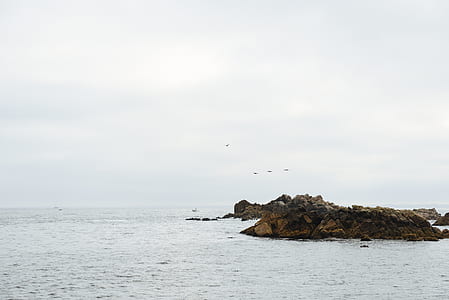 coastal rock at middle of body of water thumbnail
