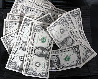 1 US dollar banknotes on black surface thumbnail