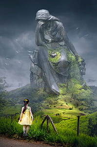girl in yellow sundress in front of a giant woamn statue thumbnail