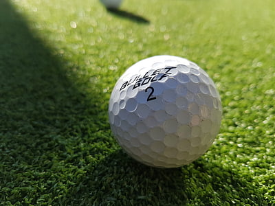 macro photography of white Bullet Golf 2 golf ball thumbnail