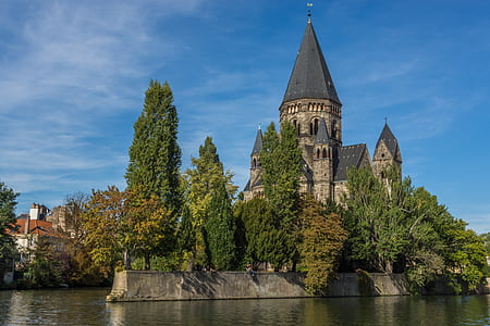 gray concrete castle surrounded by trees thumbnail