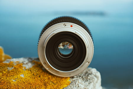 gray telephoto lens on gray rock thumbnail