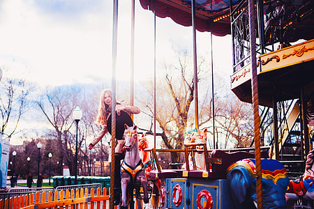 woman riding horse carousel thumbnail