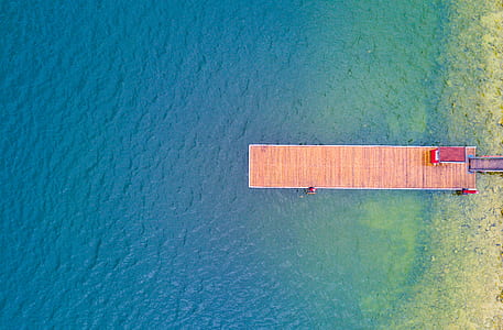 brown dock and calm body of water thumbnail