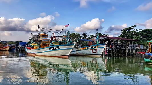 two white boats on body of water thumbnail
