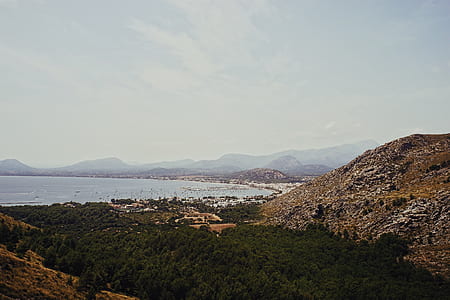landscape photography of mountain and body of water thumbnail