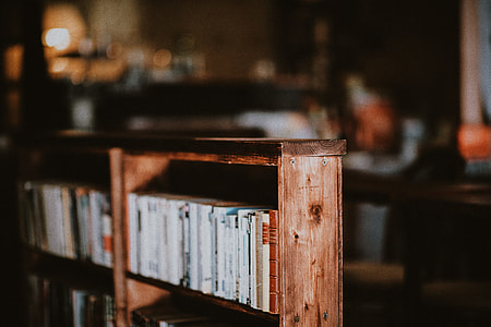 stacked book on brown wooden bookcase thumbnail