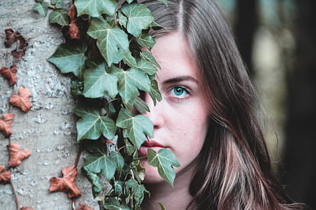 woman hiding on tree trunk thumbnail