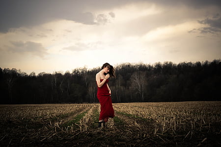 woman standing on brown grass thumbnail