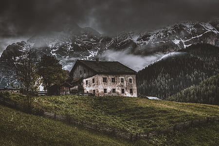 concrete house near mountain alps under stratocumulus clouds thumbnail