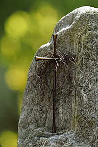 brown cross decor on gray rock thumbnail