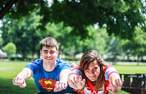 boy and girl planking under tree photo thumbnail