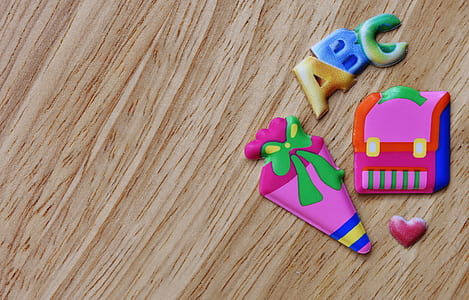 assorted-color toys on brown wooden surface thumbnail
