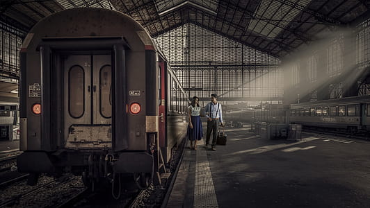 woman and man beside train photo thumbnail