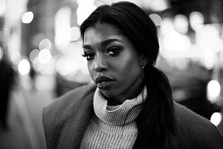 woman wearing coat and turtle-neck top grayscale photo thumbnail