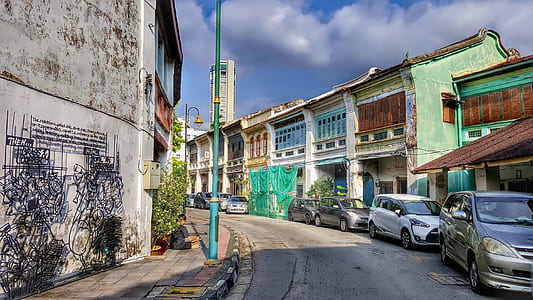 vehicles parked near buildings at daytime thumbnail