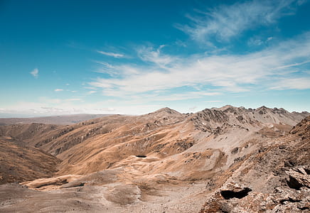 brown mountain under blue sky at daytime thumbnail