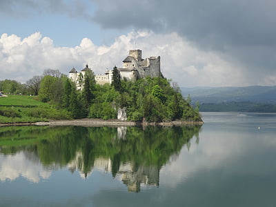 gray concrete castle near body of water during daytime thumbnail