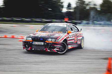 multicolored race car drifting during daytime thumbnail