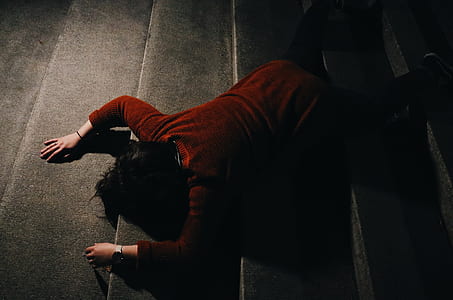 person kneeling on road thumbnail