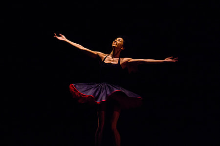 woman in purple dress with arms wide open while smiling thumbnail