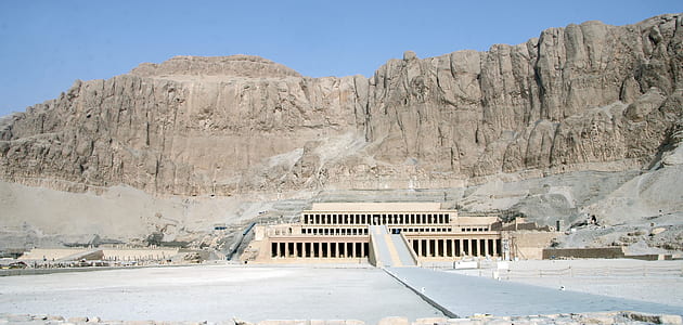 white and gray concrete building near gray mountains under blue sky during daytome thumbnail