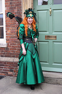 woman wearing green and black scoop neck long-sleeve bow accent gown thumbnail