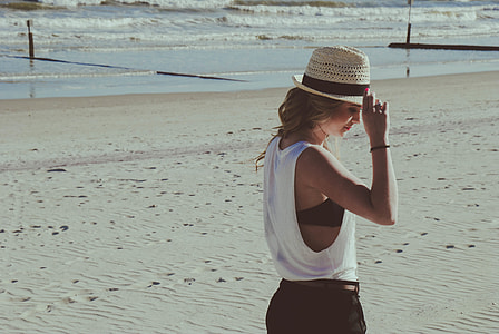 woman wearing white sleeveless top side label view near sea thumbnail