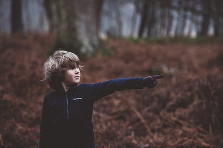 bokeh photography of a pointing using his left thumbnail