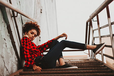 low angle photo of woman sitting on stair thumbnail