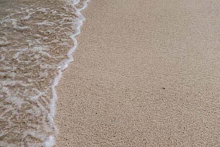 seashore with brown sands during daytime thumbnail