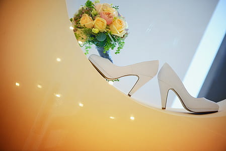 white leather stilettos beside yellow rose bouquet thumbnail