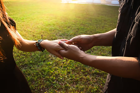 couple holding hands in daytime thumbnail