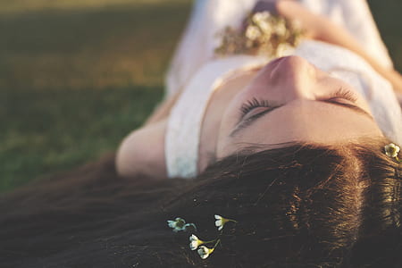 woman lying on green grass at daytime thumbnail