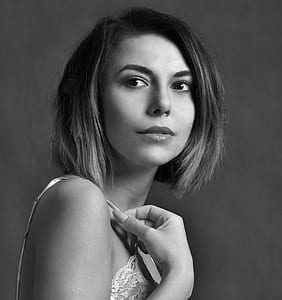 grayscale photography of woman in spaghetti-strap top thumbnail