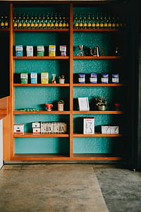 bottles and boxes arranged on brown wooden rack thumbnail