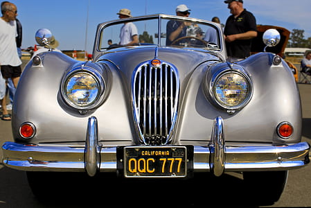 silver car on gray pavement thumbnail