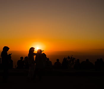 Silhouette Photograph of Several People during Golden Hour thumbnail