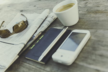 white slide phone on top of brown wooden surface thumbnail