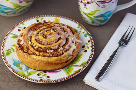 cinnamon bread with glaze on dessert plate near dessert fork thumbnail