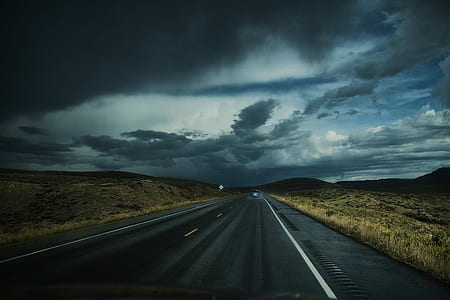 gray asphalt road under gray cloudy sky thumbnail