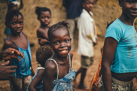 selective focus photography of smiling child walking beside childrens thumbnail