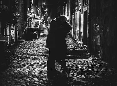 black and white photo of man and woman kissing thumbnail