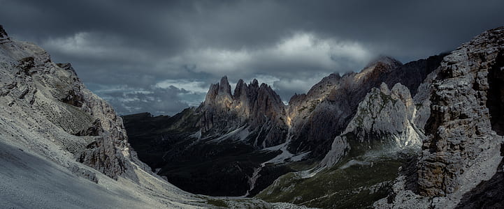 fault-block mountain covered with snow under cloudy sky thumbnail