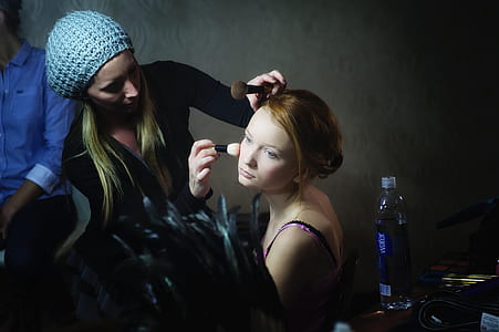 woman wearing black jacket holding makeup brush thumbnail